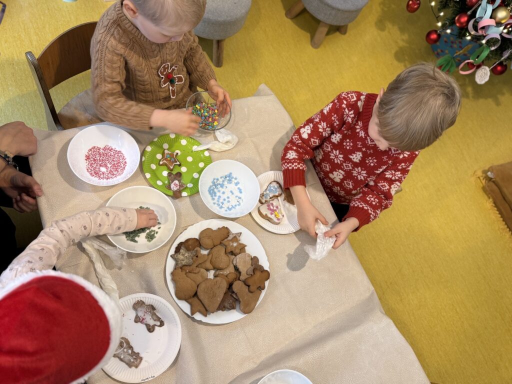 Dzieci dekorują pierniki świąteczne, wspólna aktywność w
przedszkolu